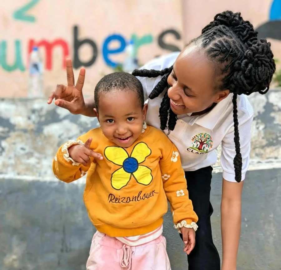 Clara Mushi with a young child during an orphanage visit